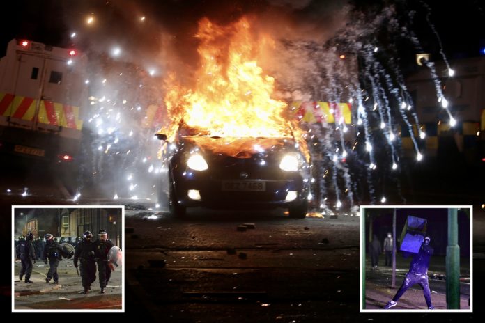 Belfast rioters kidnap a car and set it on fire while throwing stones at the police on the eighth night of violence

