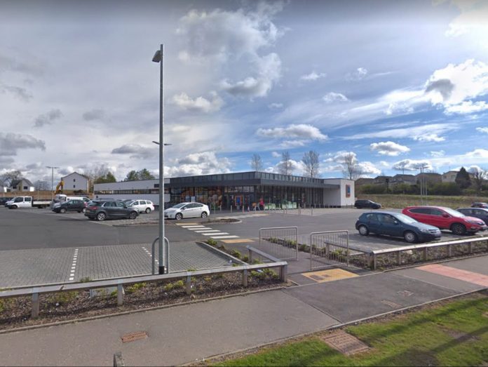 Glasgow riot police crash into Newton Mearns supermarket after the car is mounted on the pavement

