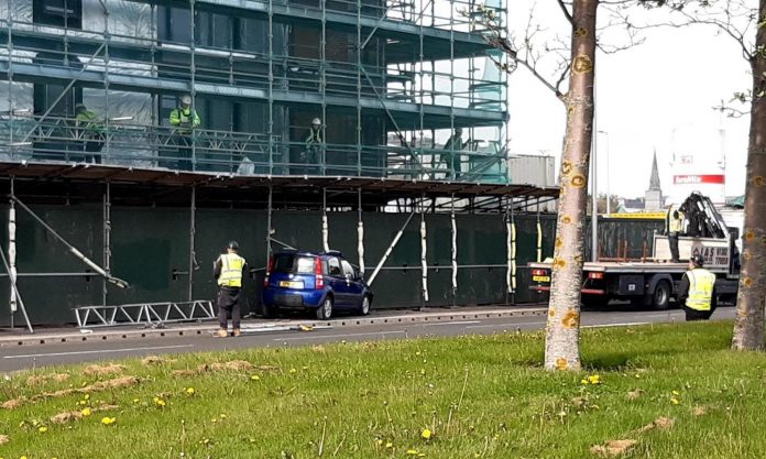 Police close the road for safety after the car collides with the scaffolding in Dundee

