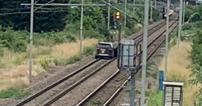 Man charged after driving a stolen car along Cheshunt railroad tracks and injuring two police officers


