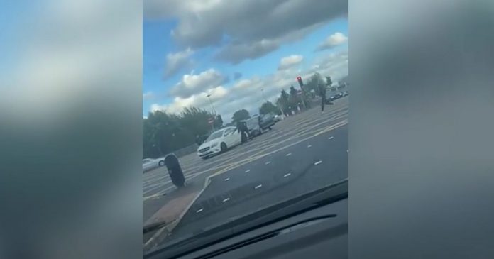Terrifying footage shows armed gangs storming a car and smashing it


