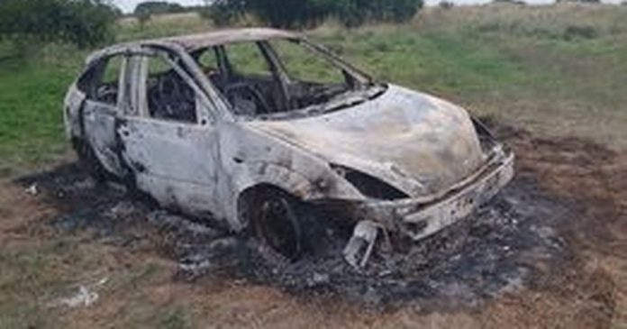 Burned-out car in the city's nature reserve 