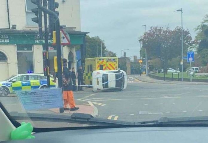 Car overturns in front of Papa John's Pizza Place after colliding with a bollard on London Road, Strood

