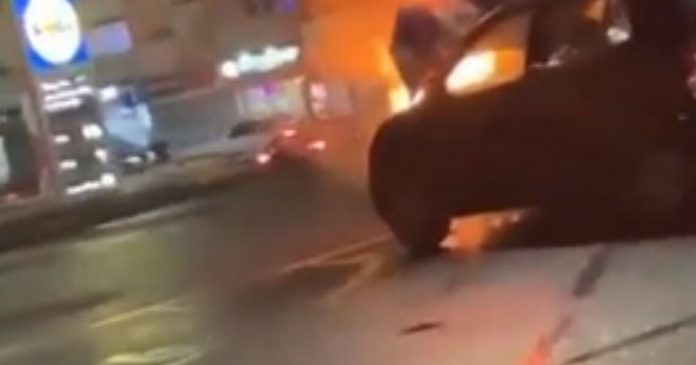 Wait a minute, vehicle in Lidl parking lot goes up in flames as a teenager in Mitsubishi sits next to it

