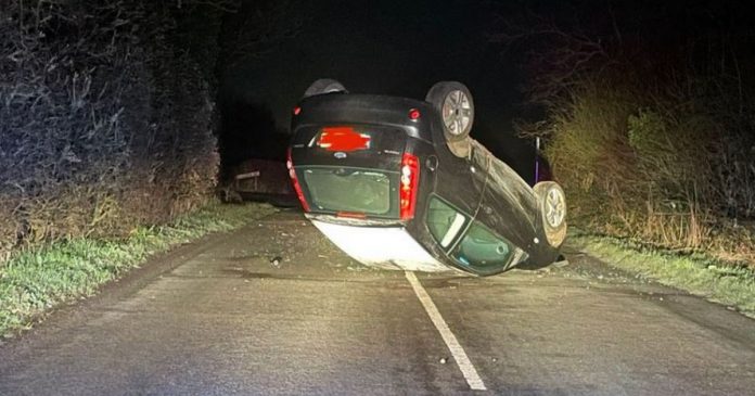 Car topples on its roof as police warn of 'icy conditions' on the road

