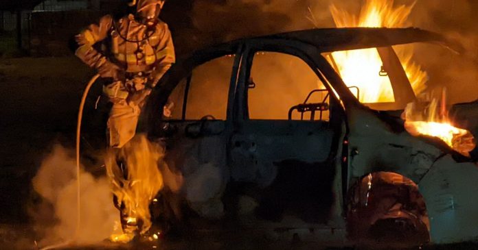 Firefighters dealing with a vehicle fire on a green area this weekend.