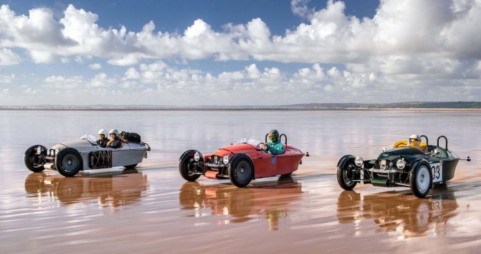 A trio of Morgan Super 3s speeding down wet sand